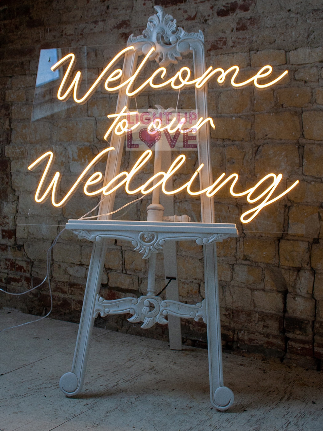 Welcome to our Wedding Neon sign on White Easel