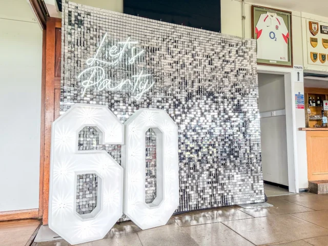 🪩 ✨ Let’s Party!! Silver setup for a 60th birthday celebration at @hertfordrfc with our silver sequin wall, neon sign and light up numbers.

📍Our Light up Number Hire service is available throughout Hertfordshire, London and surrounding counties.

📩 Just enquire with your event date and venue postcode and we will send you a quote.

*
*
*
*
*
#lightuplove #silversequinwall #sequinwallhire #shimmerwallhire #sequinwall #shimmerwall #shimmerwallbackdrop #eventstyling #60thbirthday #lightup60 #hertford #ware #silvershimmerwall #partyhireherts #letsparty #letspartyneon